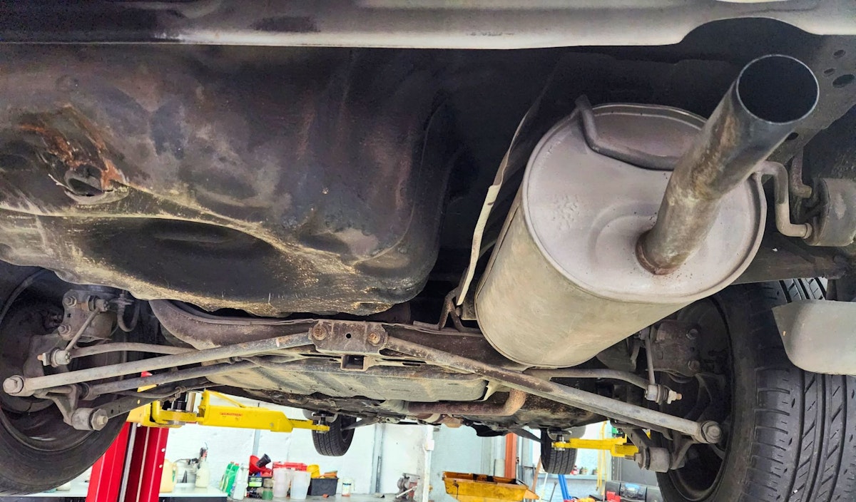 Car exhaust system with car on hoist